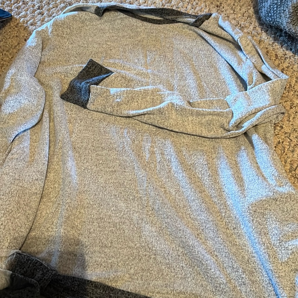 Gray knit tunic with pockets.